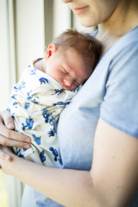 newborn baby and mom snuggling