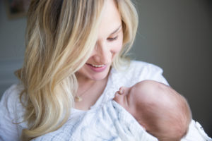 mom looking at newborn baby