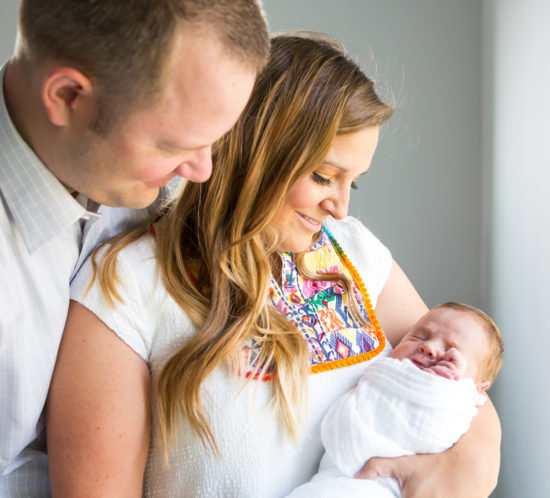 parents holding newborn