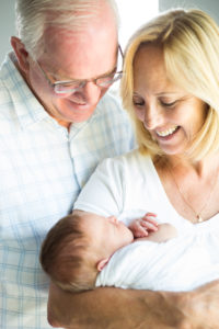 grandparents holding newborn