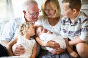 grandparents with grandkids and newborn in-home