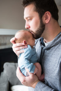 dad with newborn kissing forehead