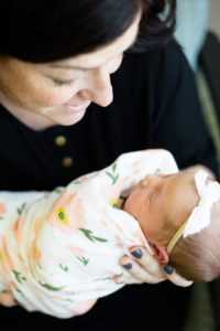 mom looking at newborn baby