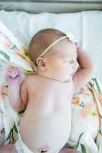 newborn stretching arms
