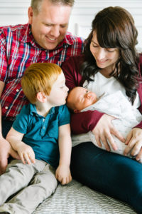 family looking at newborn baby