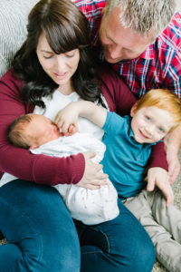 family looking at newborn baby
