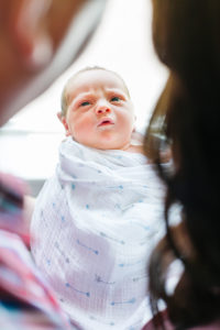newborn looking at parents