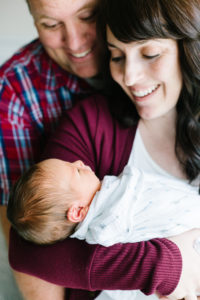parents holding newborn baby