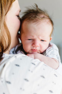 newborn baby boy snuggling over mom's shoulder