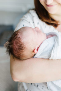 newborn baby being held by his mom