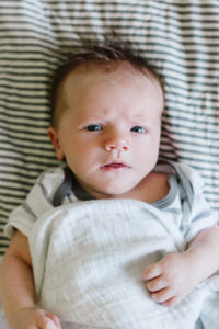 newborn baby boy looking straight at the camera