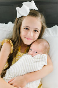 Oldest sister holding new baby brother