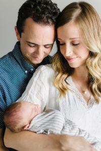 mom and dad holding newborn