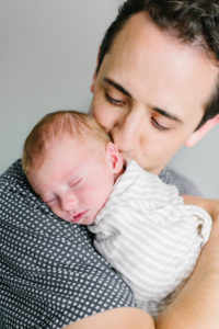 dad snuggling new baby boy