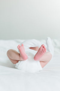 newborn baby boy toes and feet on white bed