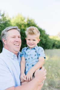 Grandpa holding grandson and laughing