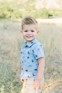 Little boy in a field looking at the camera