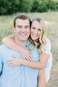 Cute couple with wife holding husband around the shoulders