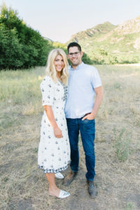 Couple photo in a field with the mountains