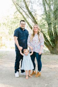 Child holding hands with parents