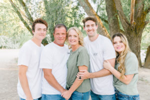 Family looking at camera snuggling together
