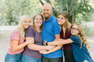 Family snuggling together for group photo