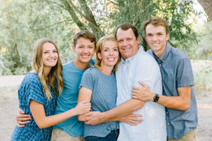 Family snuggling together for family photo