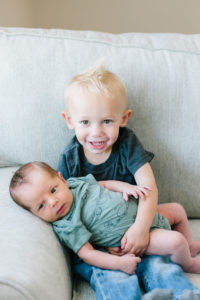 Baby brother holding newborn baby boy