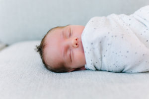 Newborn baby boy swaddled and sleeping