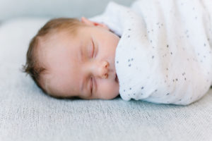 Newborn baby boy snuggled in blankets