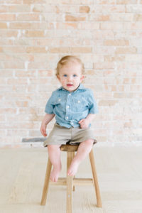 one year old sitting on a stool