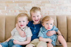three brothers with arms around each other
